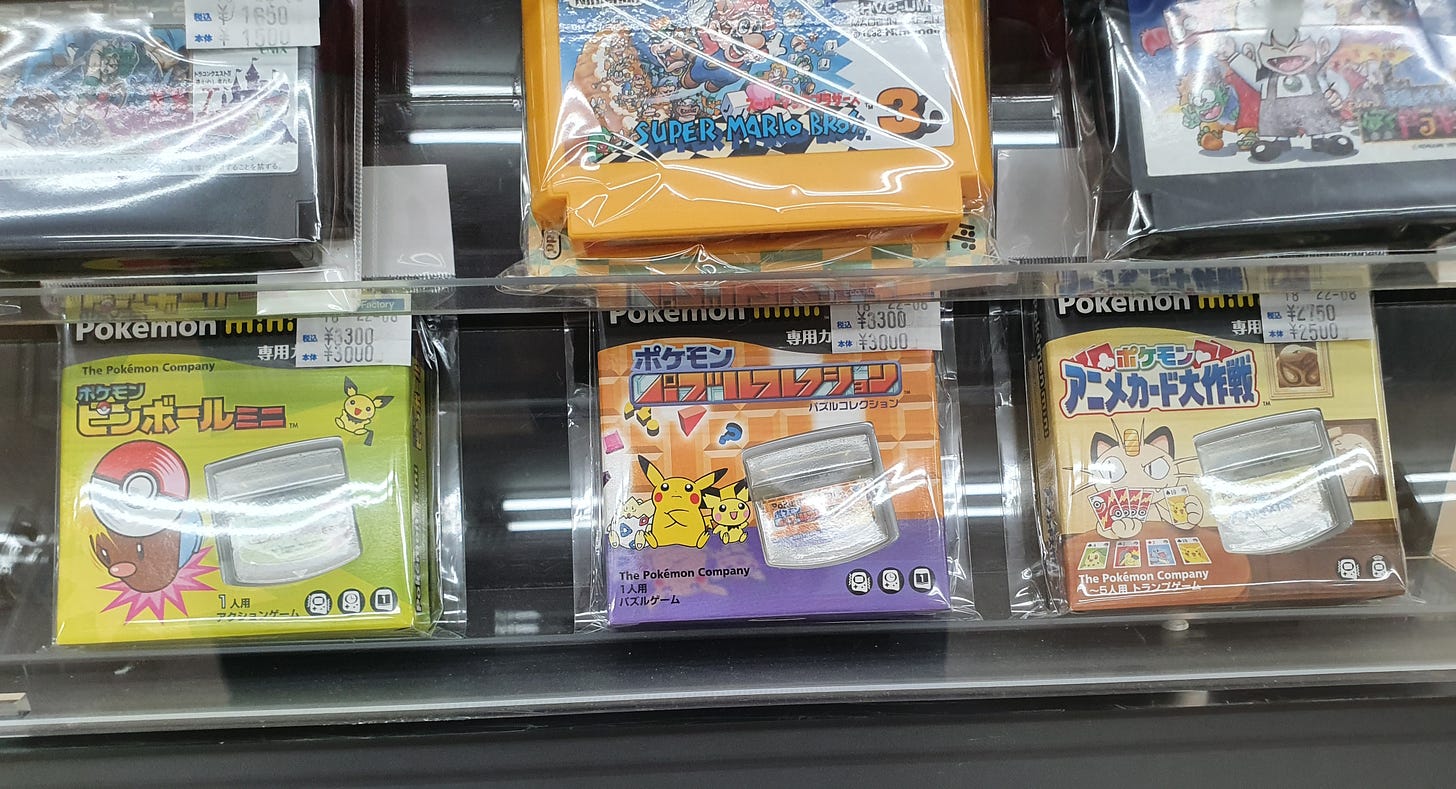 A collection of Japanese Pokémon Mini games in their original boxes
