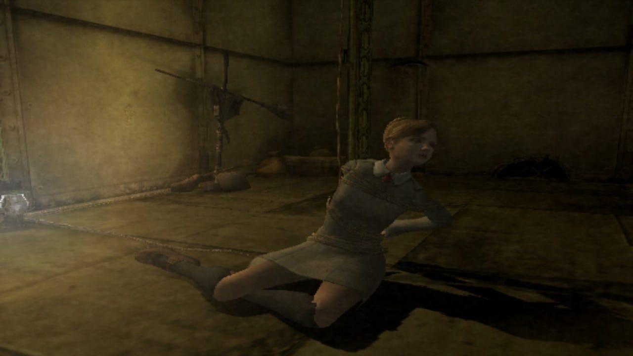 A screenshot of Jennifer from the start of Rule of Rose, where she is sitting on the ground but is tied to a support pillar of the building.