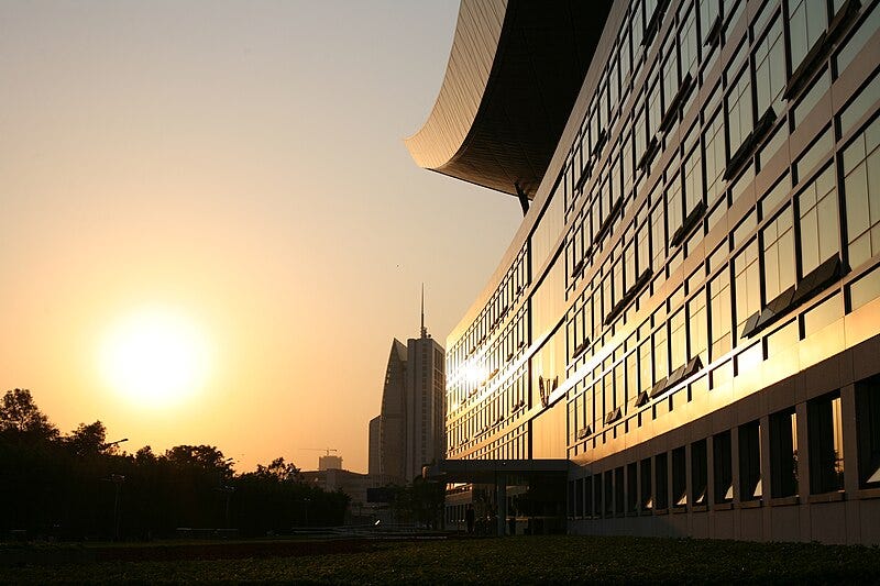 File:One side of Shenzhens city hall glimmers in the sunset..jpg