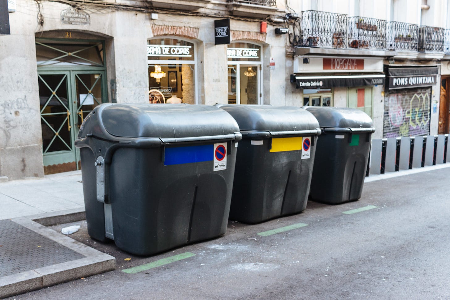 Paper, plastic, and trash bins in Madrid, Spain