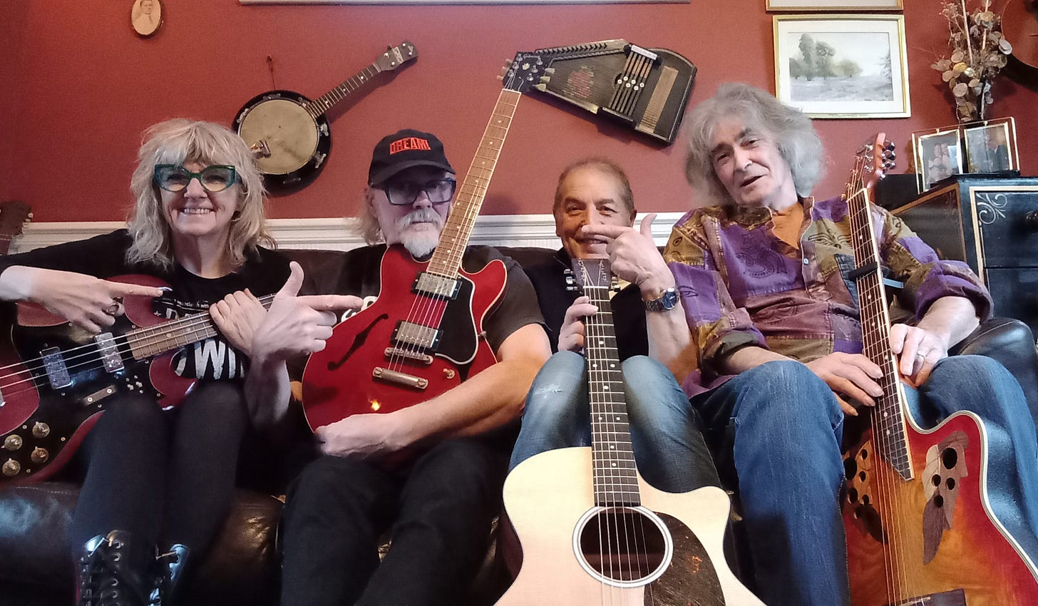 Four people with guitars on a couch