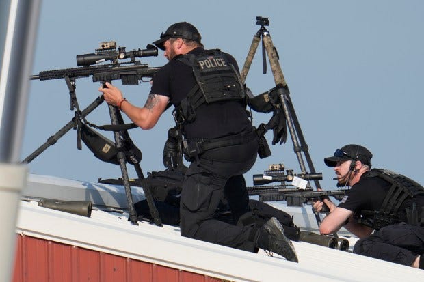 Police snipers return fire after shots were fired while Republican presidential candidate former President Donald Trump was speaking at a campaign event in Butler, Pa., on Saturday, July 13, 2024. (AP Photo/Gene J. Puskar)