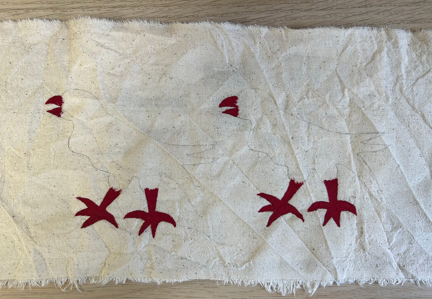 Pencil and red paint on cloth, in bird shapes