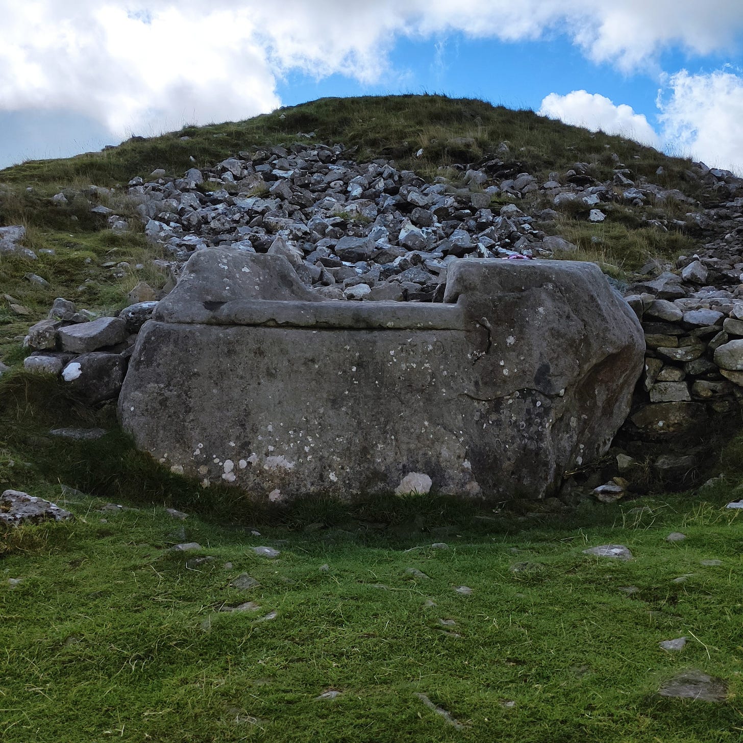 Stone throne resting into an ancient mound