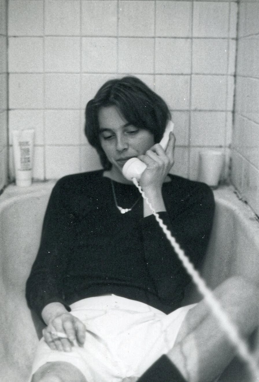 Woman making phone call from a bath tub