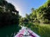 Image of tip of pink and white boat on Indian River in Dominica