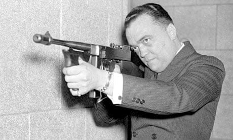 FBI director J Edgar Hoover aims machine gun FBI director J Edgar Hoover aims machine gun