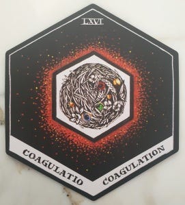 a hexagon shaped card shows a tangle of plant matter inside a white hexagon with red shading around the outside and a black background.
The words 'coagulo' and  'coagulation' are written at the bottom, and LXVI at the top.