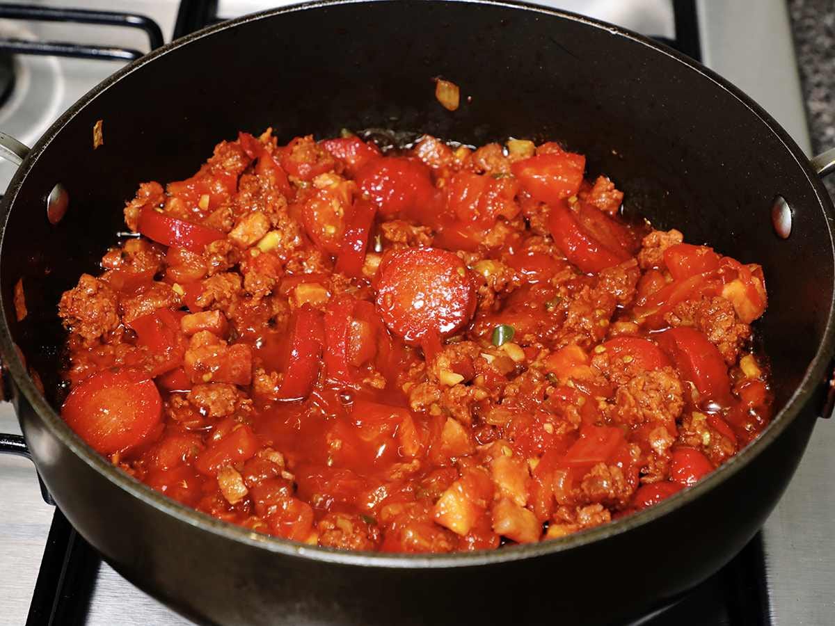frijoles charros ingredients cooking in pan