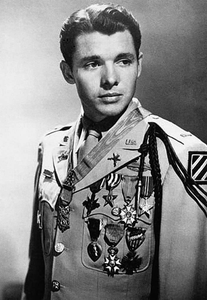 Black and white photo of Lieutenant Audie Murphy. In the photo Audie Murphy is in formal uniform adorned with the Medal of Honor and numerous other combat awards he has received. Black and white photo of Lieutenant Audie Murphy. In the photo Audie Murphy is in formal uniform adorned with the Medal of Honor and numerous other combat awards he has received.