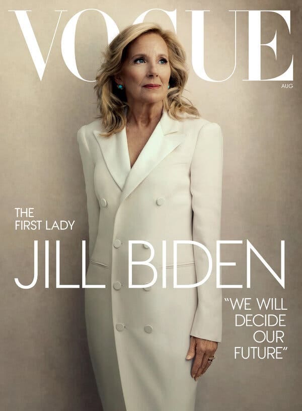 The cover of the August 2024 issue of Vogue, with Jill Biden on the cover. She is standing against a beige background and is wearing a white dress.