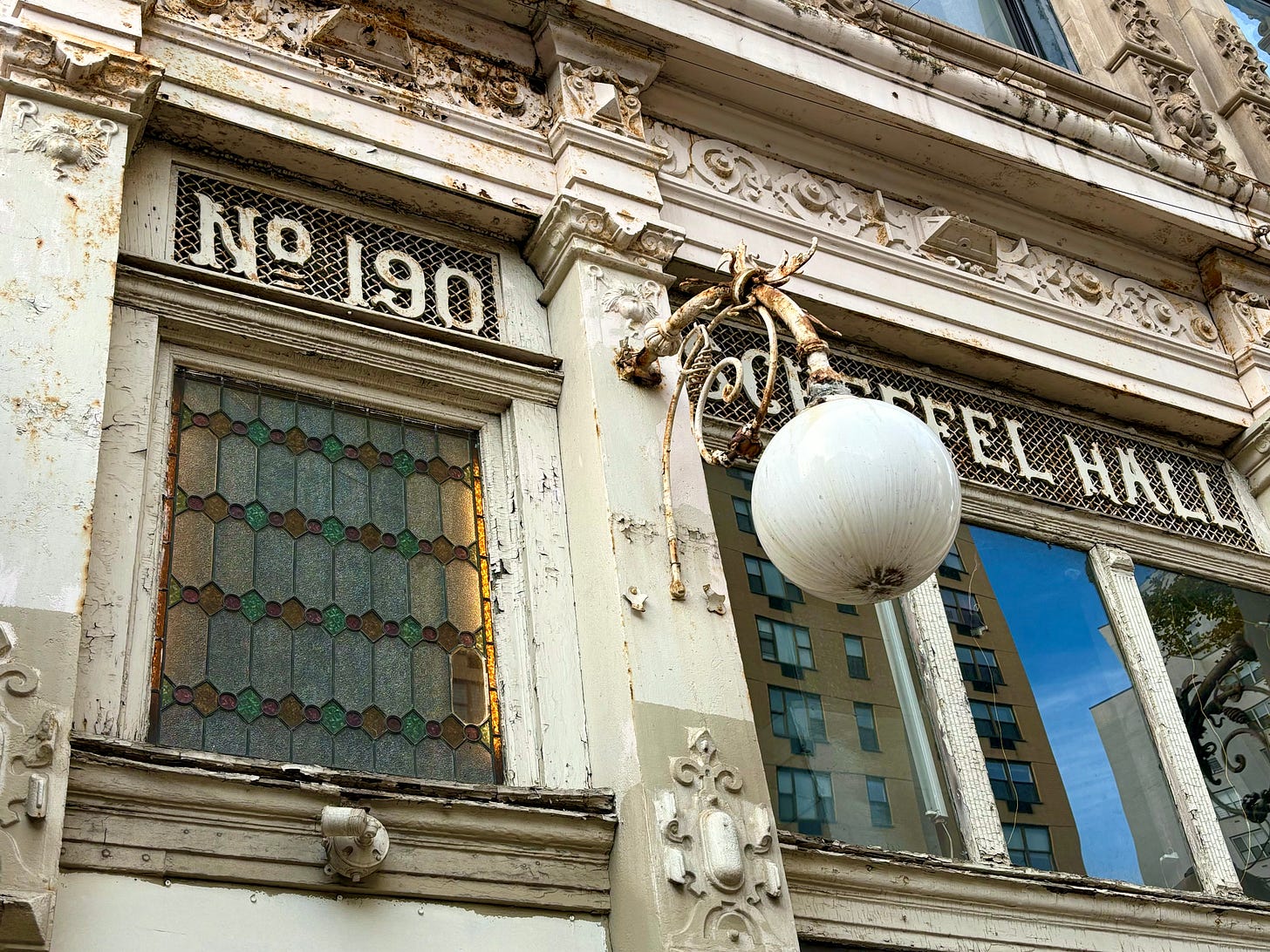 A close-up of the No 190, the colored window, and Scheffel Hall, and a hanging lamp.