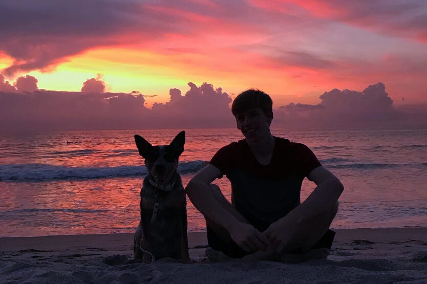 Sean the human and Scout the blue heeler enjoying a beautiful sunrise on the dog-friendly section of Cocoa Beach in Florida