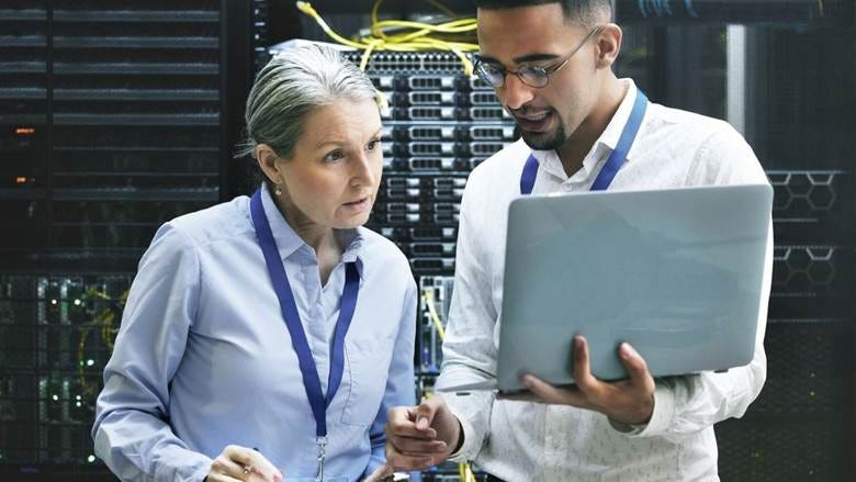 Shot of two technicians working together in a cloud server room