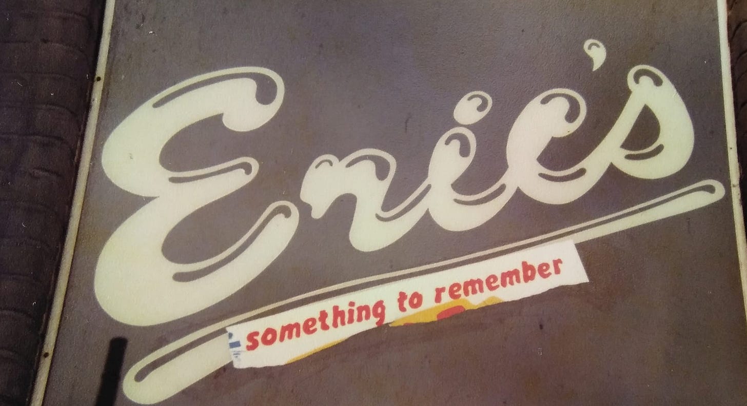 The “Eric’s” sign on the wall outside the club. Underneath, someone has pasted a line torn off a poster saying “something to remember”.