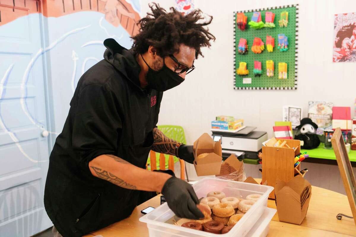 Whack Donuts owner Vandor Hill serves his vegan creations at a pop-up in 2022.