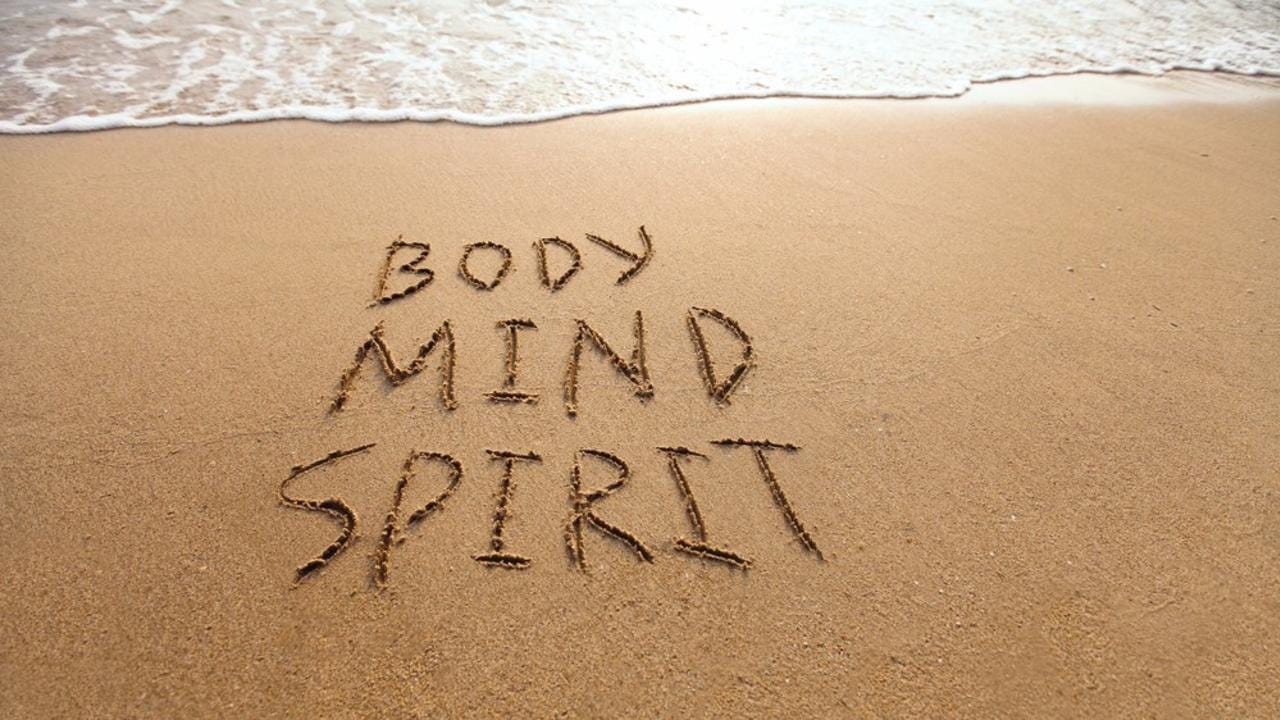 A body mind spirit written in sand

Description automatically generated