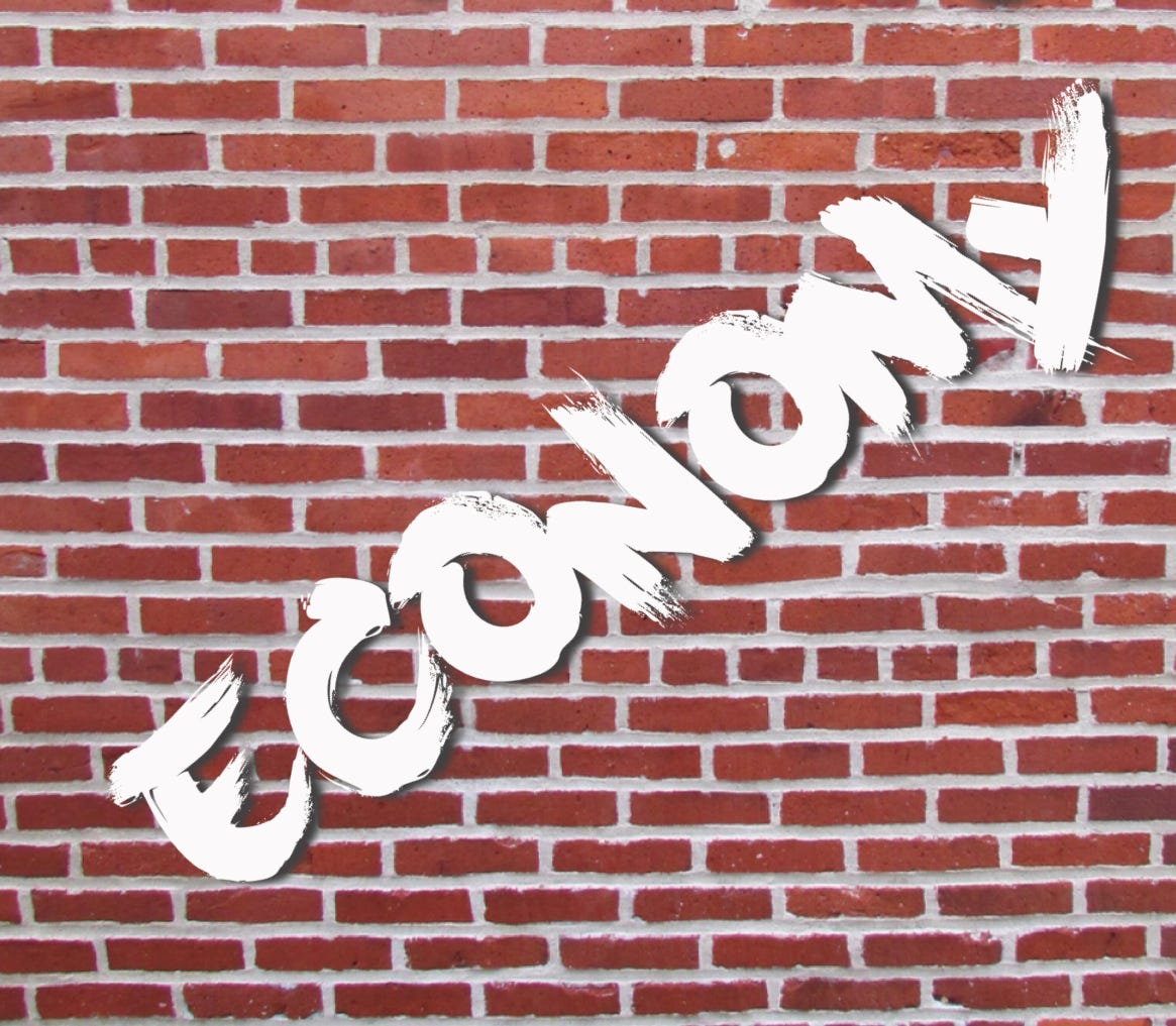 Brick wall with ‘economy’ graffiti