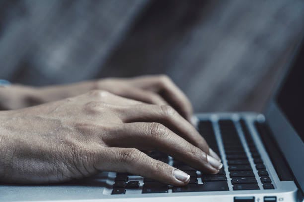 The hand of the woman who inputs the personal computer stock photo