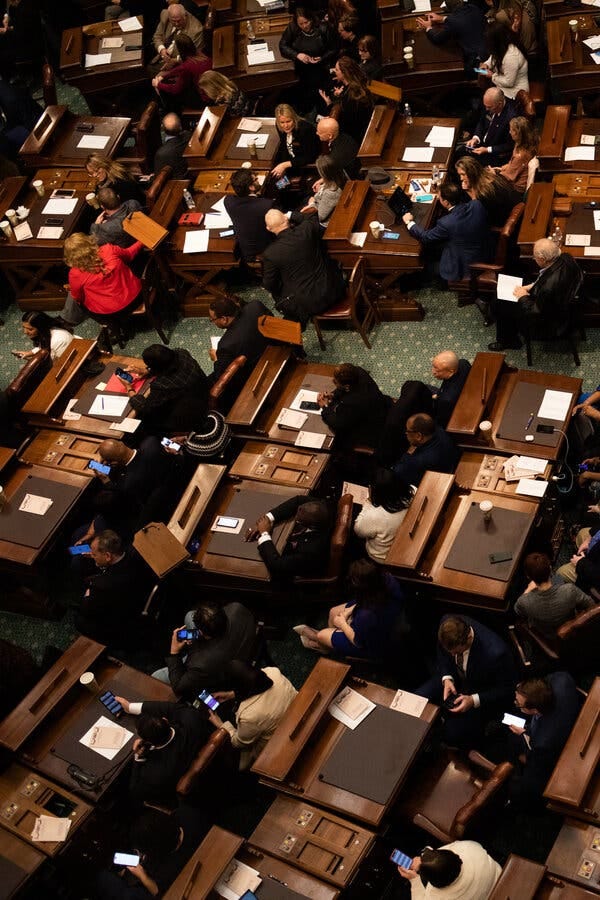 Lawmakers shown at their desks from an angle overhead.