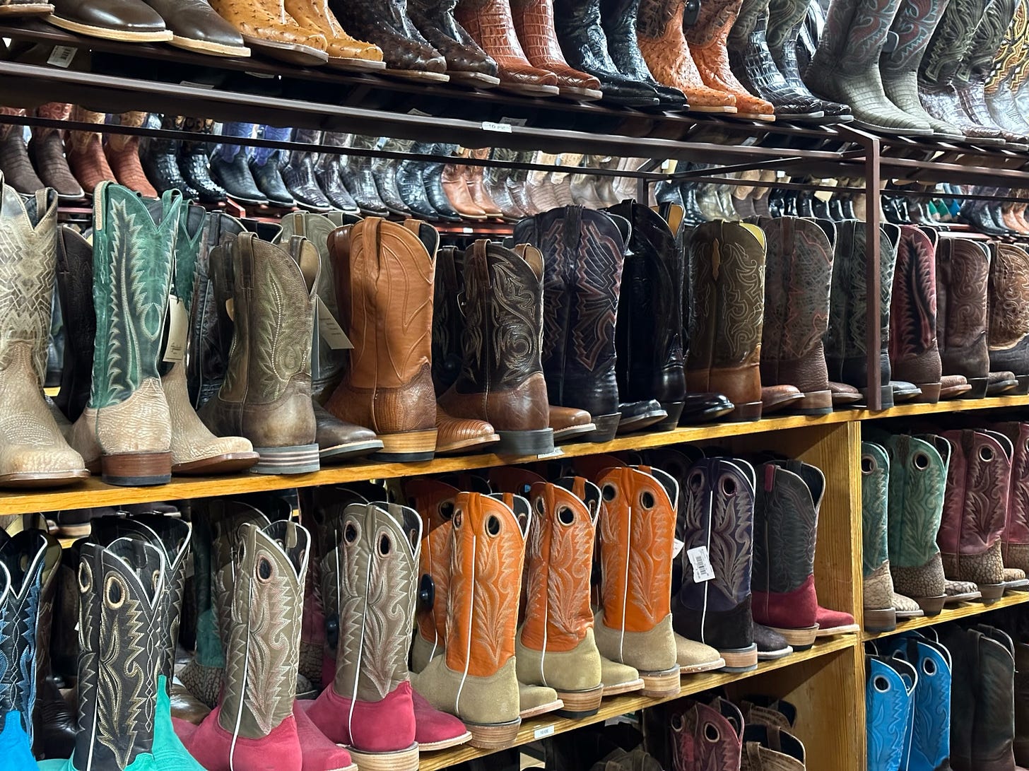 a wall of shelves of cowboy boots