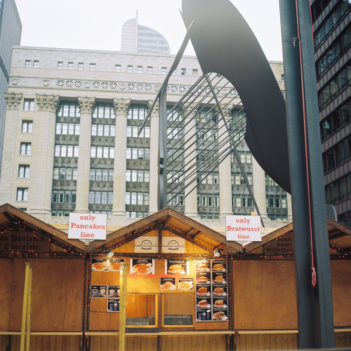 Photo of a stall at Chicago's Christkindlmarkt selling pancakes and bratwurst