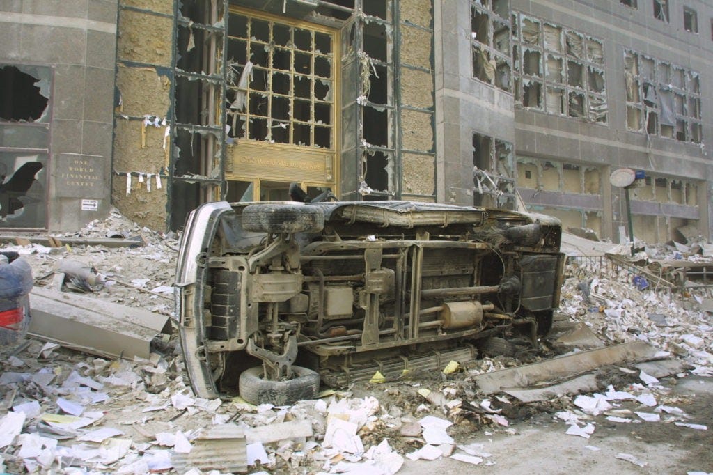 394277 05: A car sits on its side amid rubble at the World Trade Center after two hijacked planes crashed into the Twin Towers September 11, 2001 in New York. (Photo by Ron Agam/Getty Images)