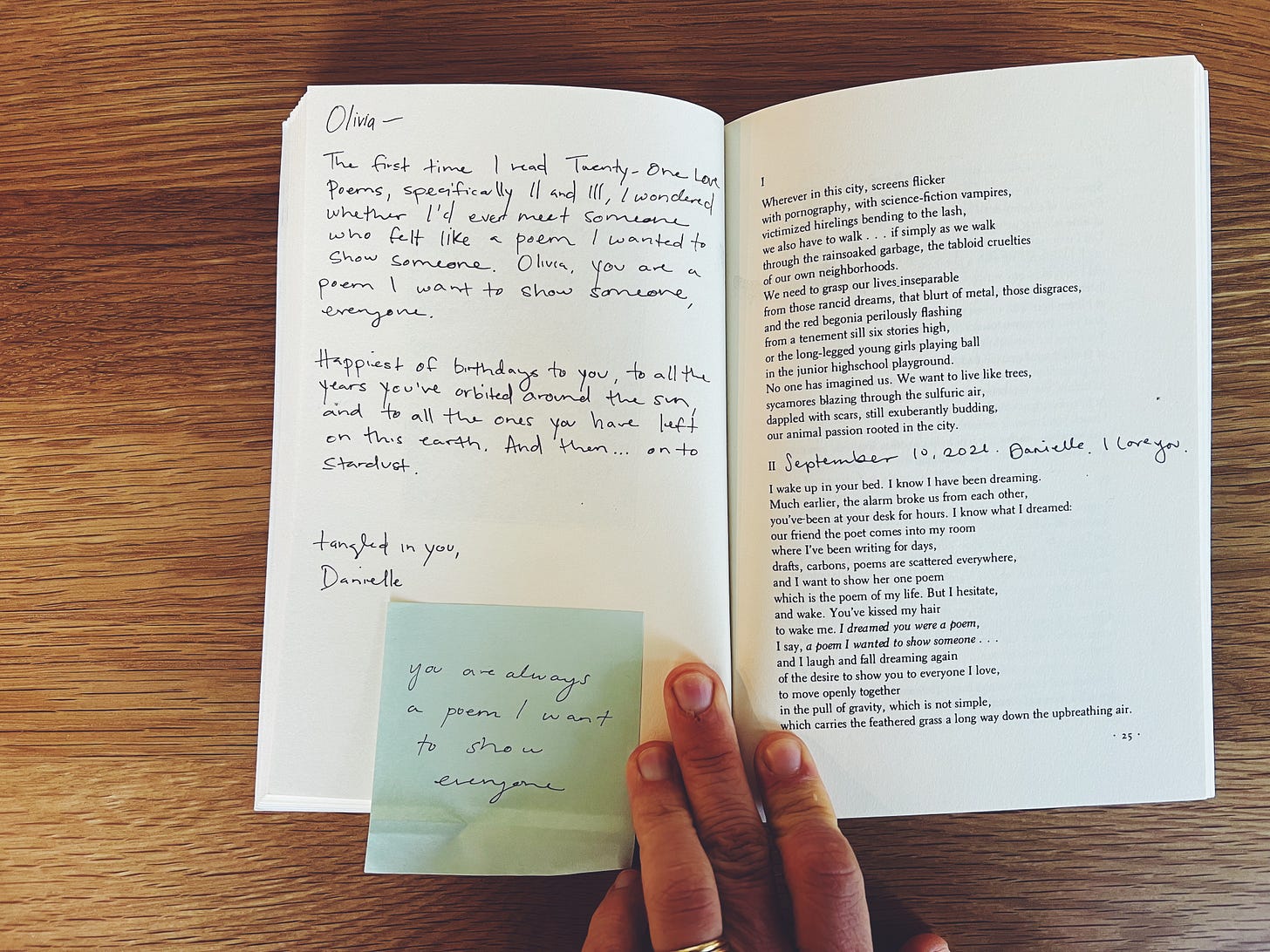 An open poetry book, with handwritten notes and sticky note inside saying "you are always a poem I want to show everyone"