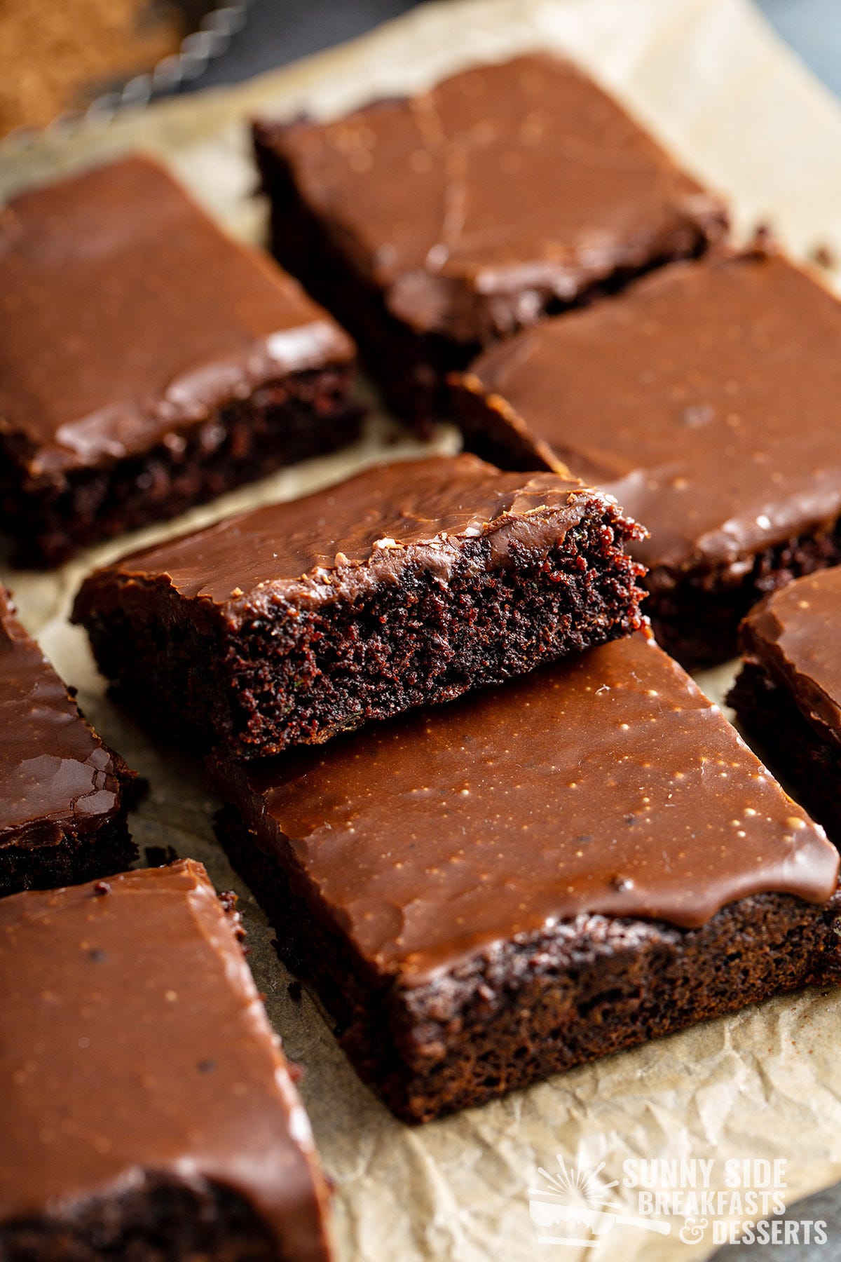 Zucchini brownies on parchment paper.