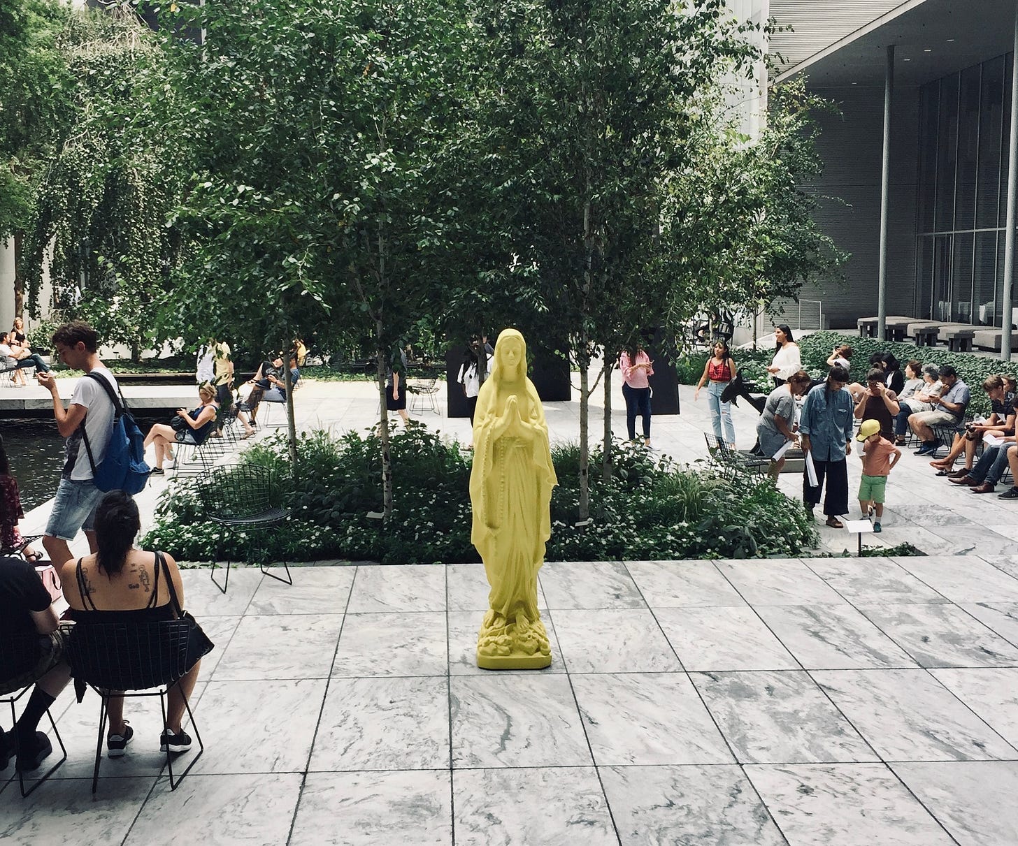 A bright yellow Madonna statue