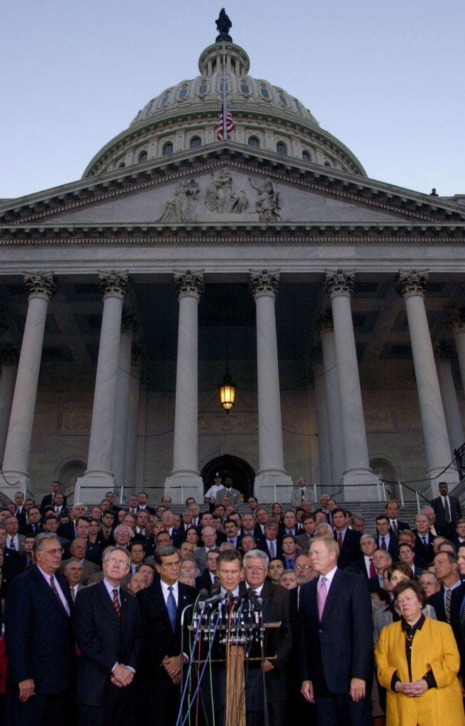 ** FILE ** From front left: Rep. Dick Armey, R-Texas, Sen. Harry Reid, D-Nev., Sen. Trent Lott, R-Miss., Senate Minority Leader, Sen. Tom Daschle, D-S.D., Senate Majority Leader, House Speaker Dennis Hastert, R-Ill., Rep. Richard Gephardt, House Minority Leader, Sen. Barbara Mikulski, D-Md., and other congressional members stand together on the steps of the Capitol to show unity, Tuesday, Sept. 11, 2001, in Washington, after a day which saw two planes crashes into the World Trade Center in New York, and one into the Pentagon, all considered acts of terrorism. The showing of national and political unity, displayed after the Sept. 11 attacks, is missing in 2005 after Hurricane Katrina and her deadly winds have subsided. (AP Photo/Kenneth Lambert)