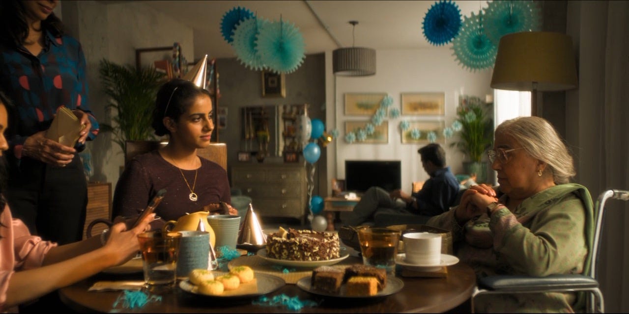 This image shows Yasmin "Yaz" Khan (played by Mandip Gill, left) and her Nani Umbreen (played by Leena Dhingra, right) celebrating Umbreen's birthday in the Khan family flat. Yaz's mother and sister stand and sit to her right (but the photo's left), while her father sits in an armchair in the middle distance.. This image shows Yasmin "Yaz" Khan (played by Mandip Gill, left) and her Nani Umbreen (played by Leena Dhingra, right) celebrating Umbreen's birthday in the Khan family flat. Yaz's mother and sister stand and sit to her right (but the photo's left), while her father sits in an armchair in the middle distance..