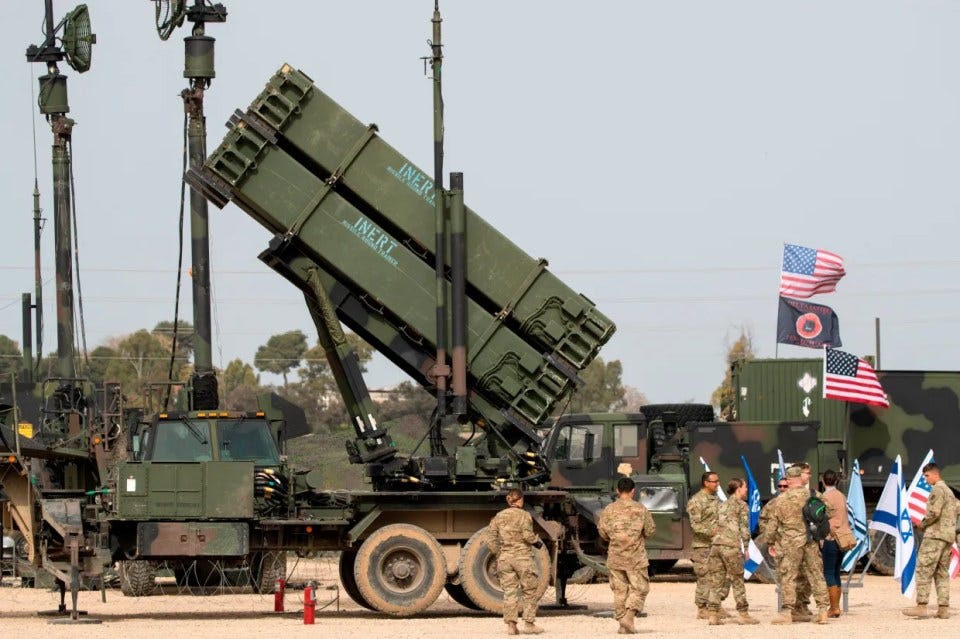 US Army missile launcher with soldiers and flags.