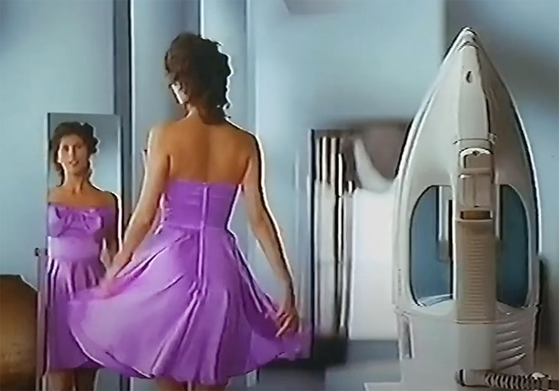 Tefal Iron advert 1990s, woman admiring floaty dress in mirror with iron in foreground