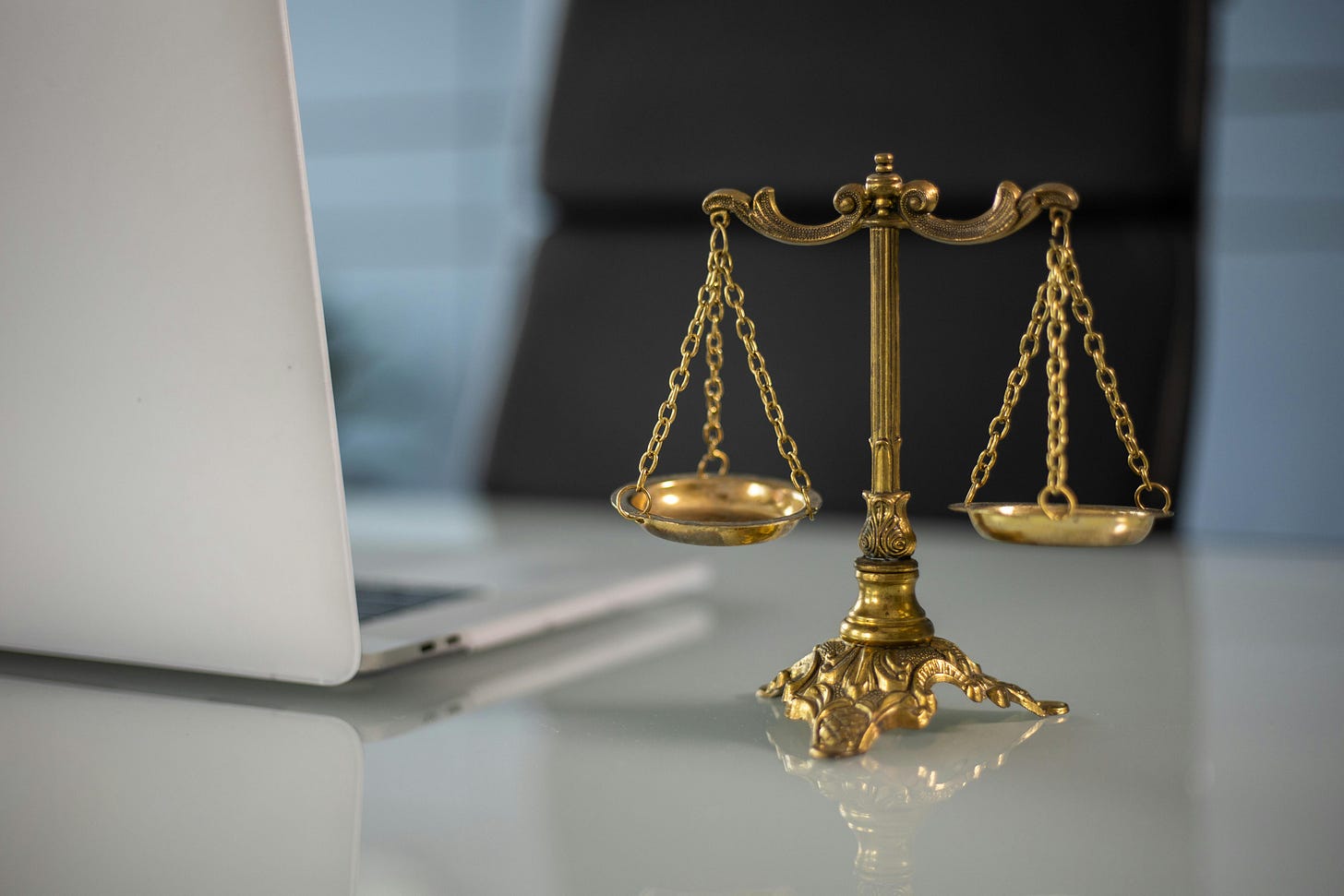 Photo of laptop and scales of justice.