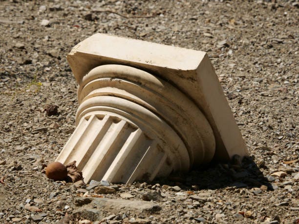 Closeup shot of a broken Greek column on the floor A closeup shot of a broken Greek column on the floor broken column stock pictures, royalty-free photos & images