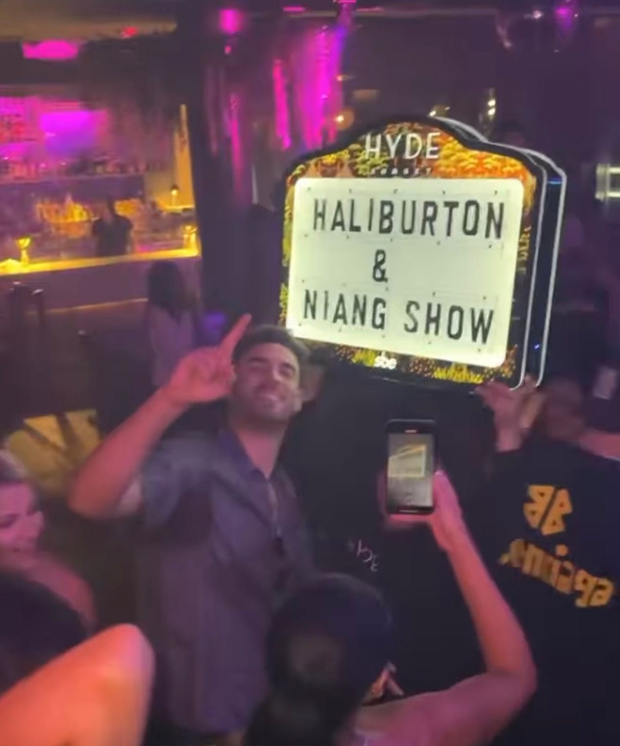 Georges Niang in front of a sign as he was able to celebrate his new contract with Haliburton in LA.