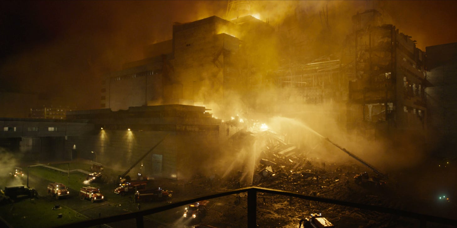 A still image from HBO’s “Chernobyl”, showing Reactor 4 on fire at night surrounded by firefighting crews.