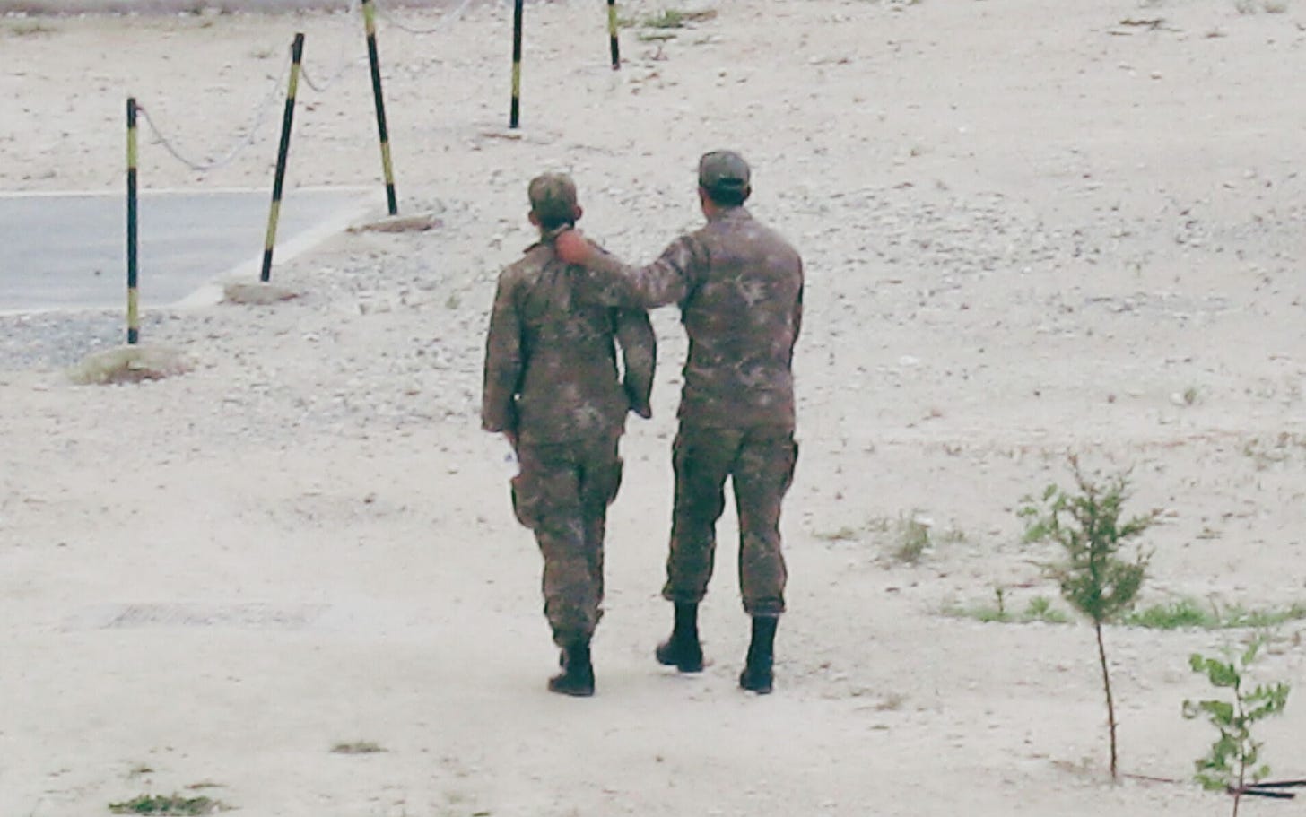 army man carrying a conscript by the scruff of the neck