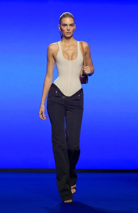 A person walking down a runway

AI-generated content may be incorrect.