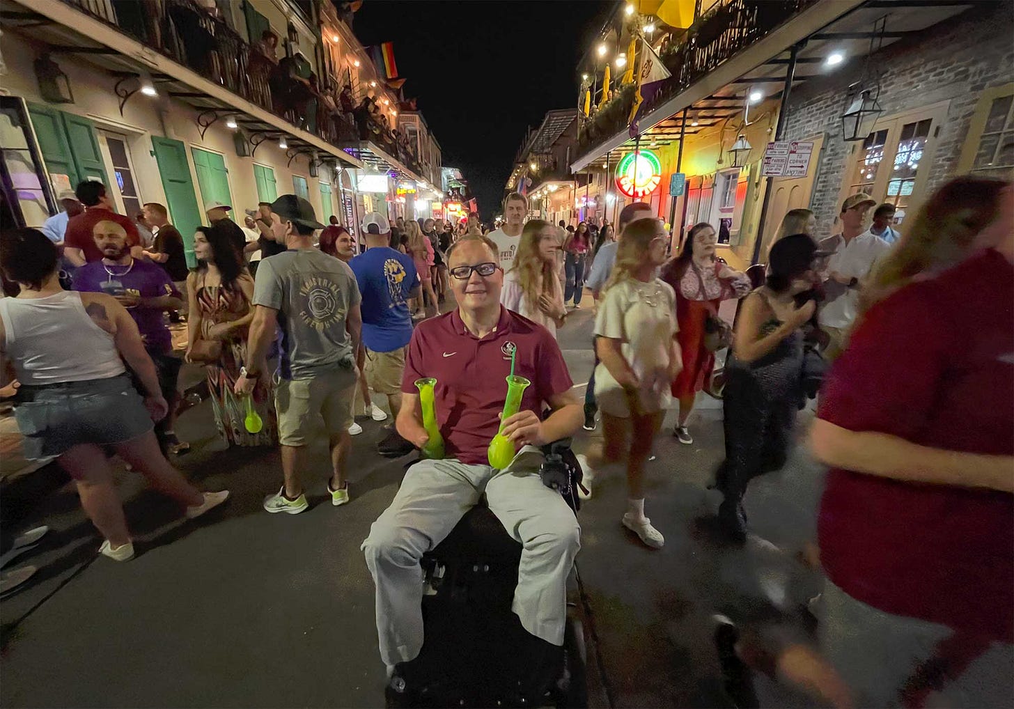 John seated in his wheelchair in the middle of Bourbon Street in New Orleans.