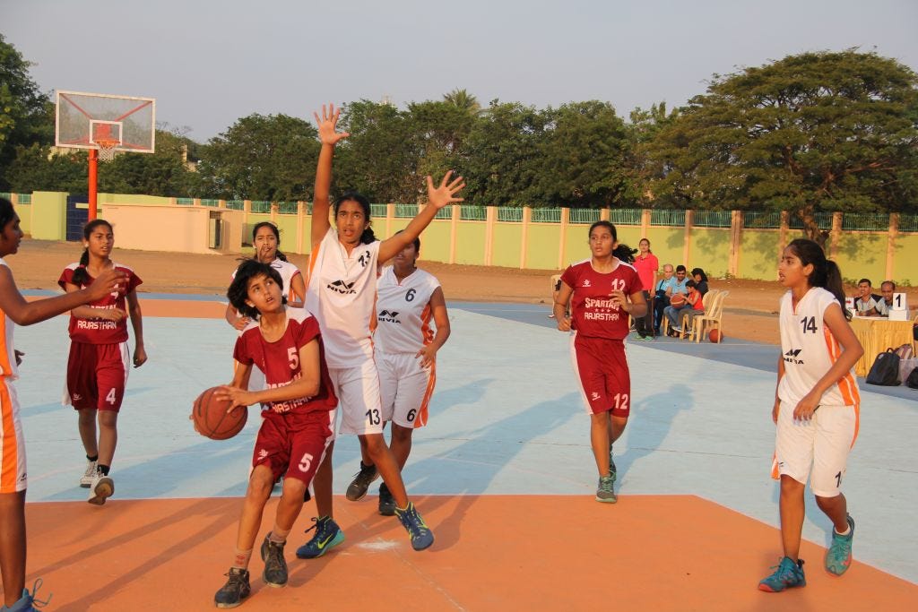 Rajasthan-player-in-maroon-drives-in-against-Telangana-in-white