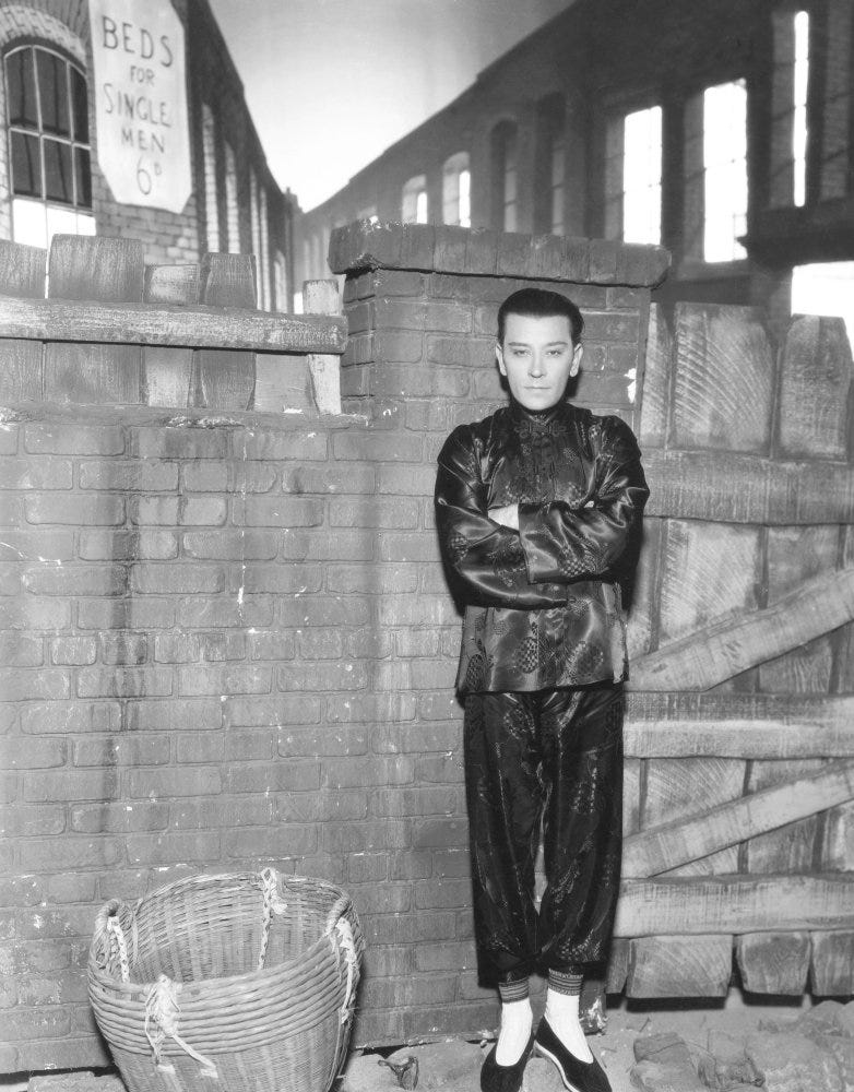 George Raft dressed in Chinese silk shirt and pants in yellowface