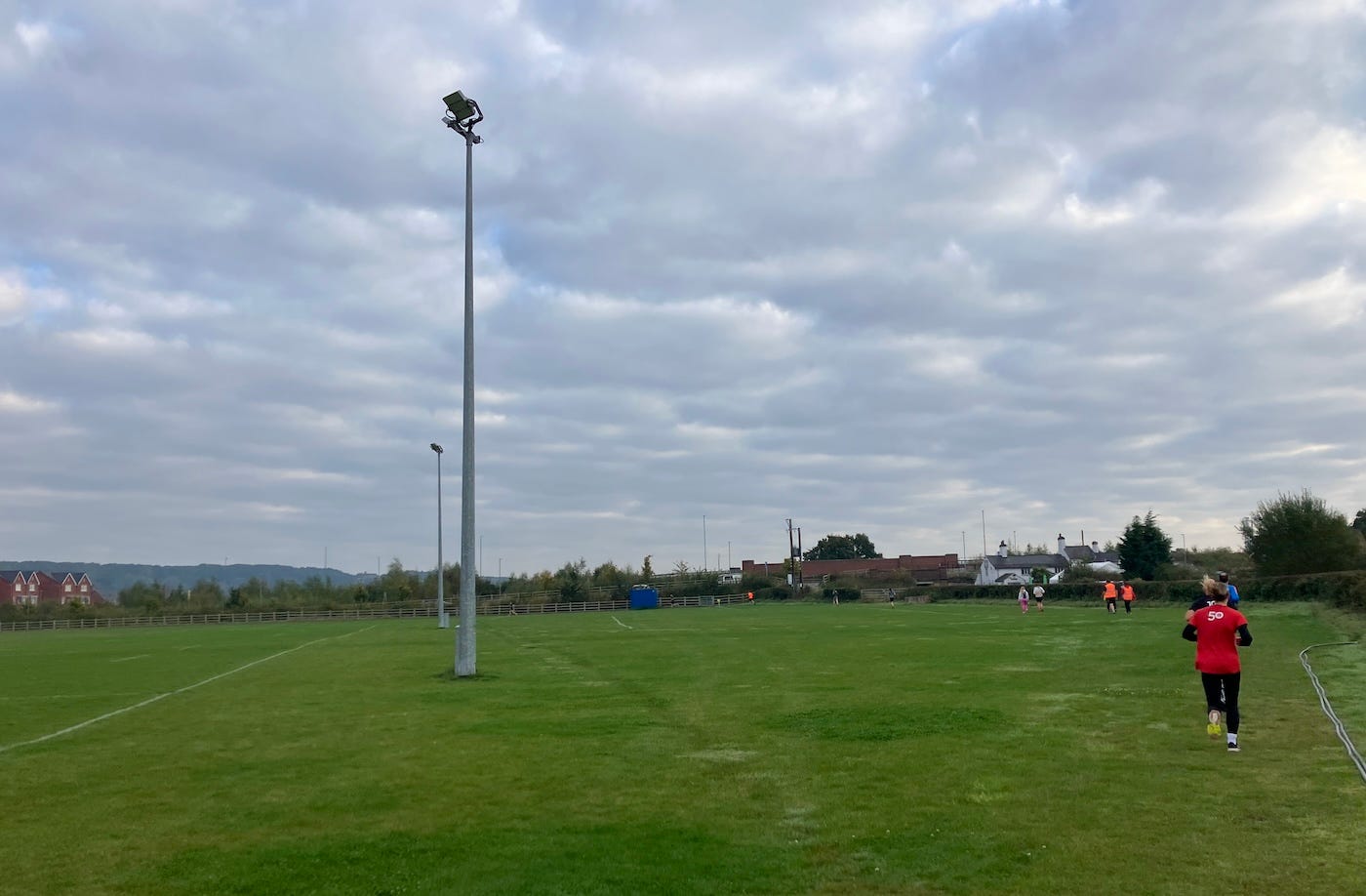 A floodlight pylon stands in the field