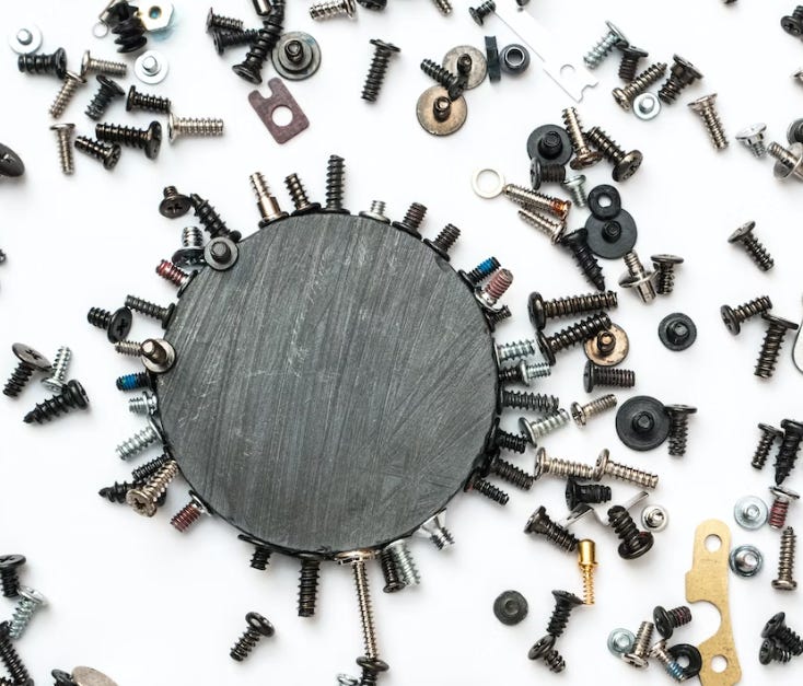 a round magnet with an assembly of screws and washers surrounding it (assemble your submission)