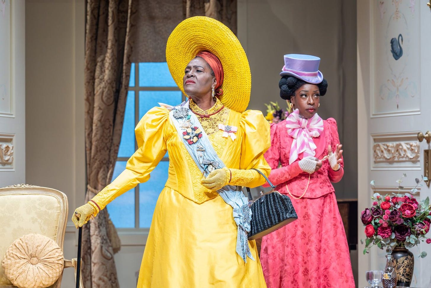 A photo of The Importance of Being Earnest at the National Theatre, showing Sharon D Clarke as Lady Bracknell in a yellow dress