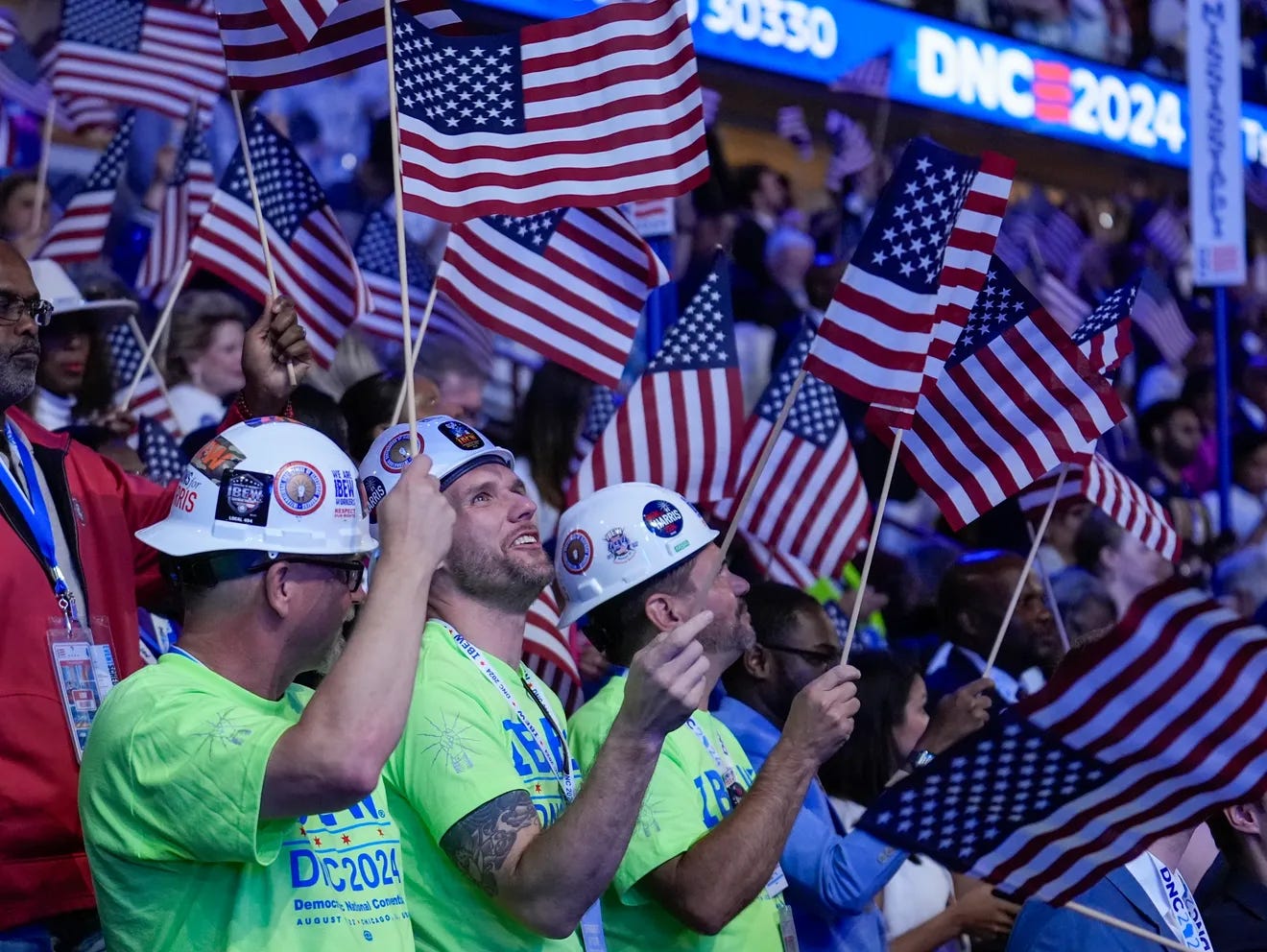 74911914007-ap-24236037287228.jpg.webpCharles Rex Arbogast, AP. Union workers in hardhats wave flags during the Democratic National Convention Thursday, Aug. 22, 2024, in Chicago.