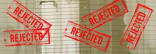 image with covered in ink stamps of the word "rejected"