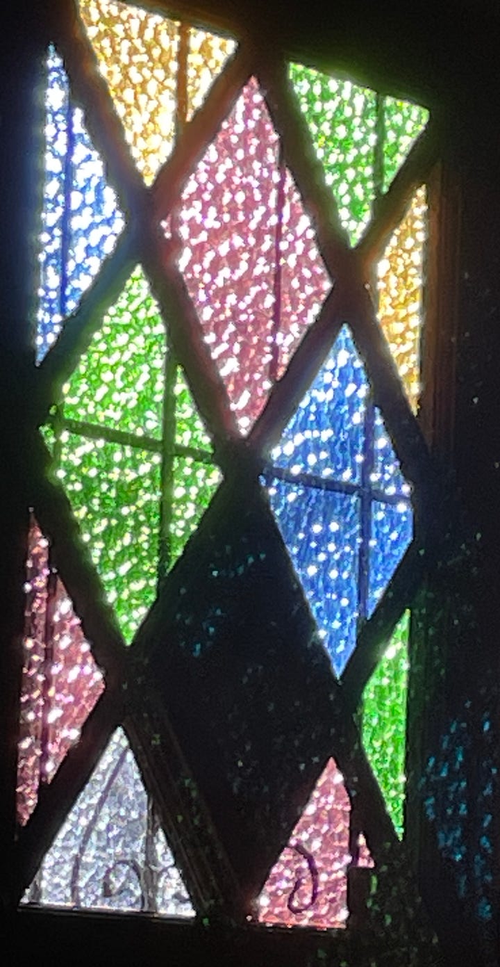 sunlight through colored glass on a door