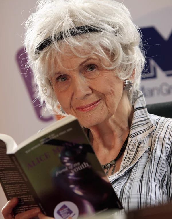 Alice Munro holding a paperback copy of her book Friend of My Youth